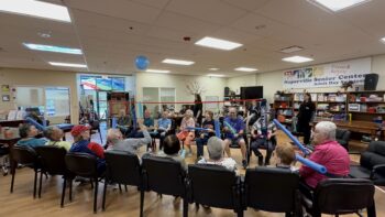 Seniors enjoying a noodle balloon activity